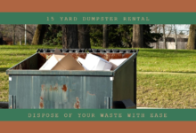 A 15-yard green dumpster filled with cardboard on a grassy field indicating rental services for easy waste disposal.